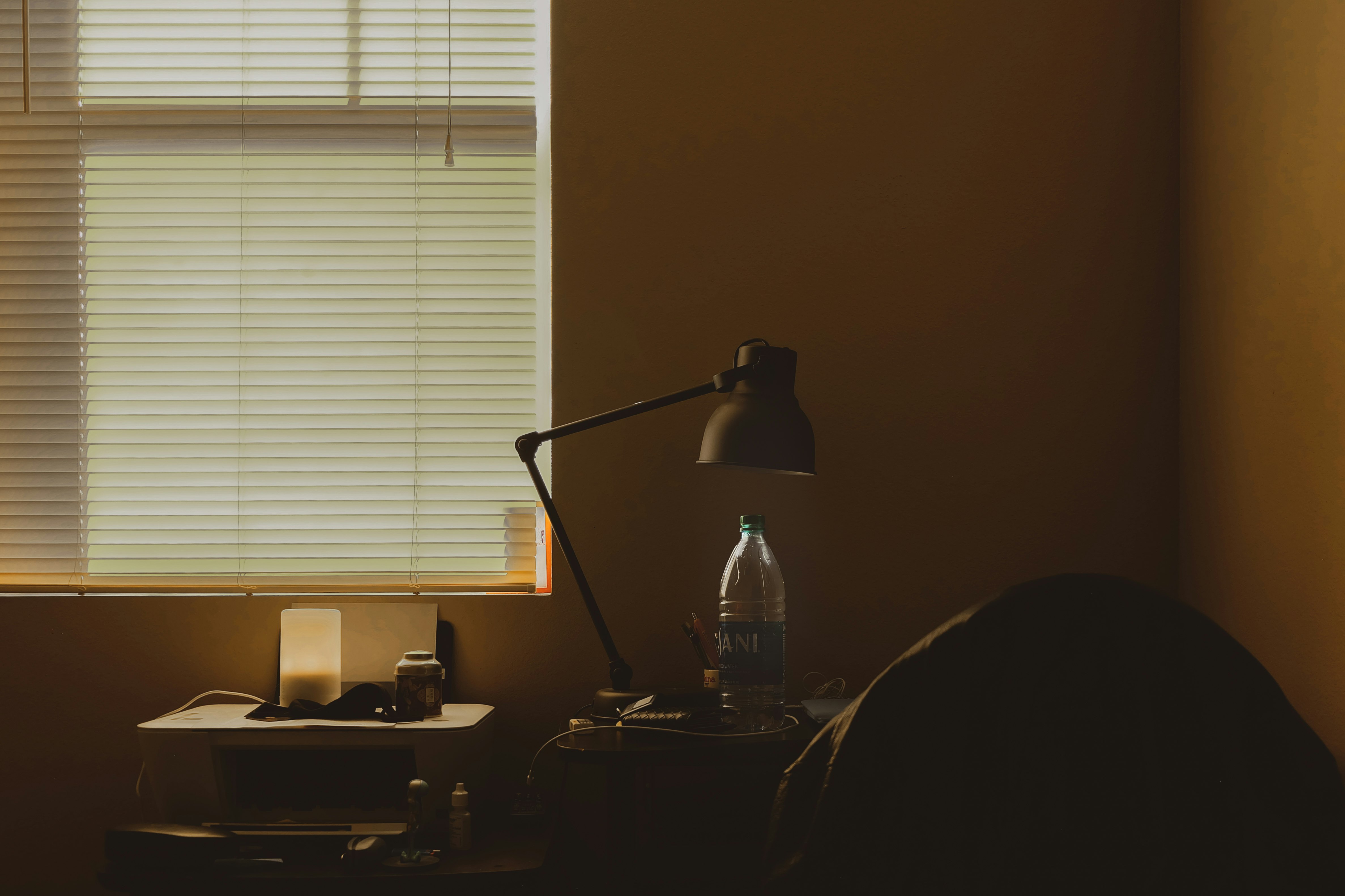 black desk lamp on brown wooden desk